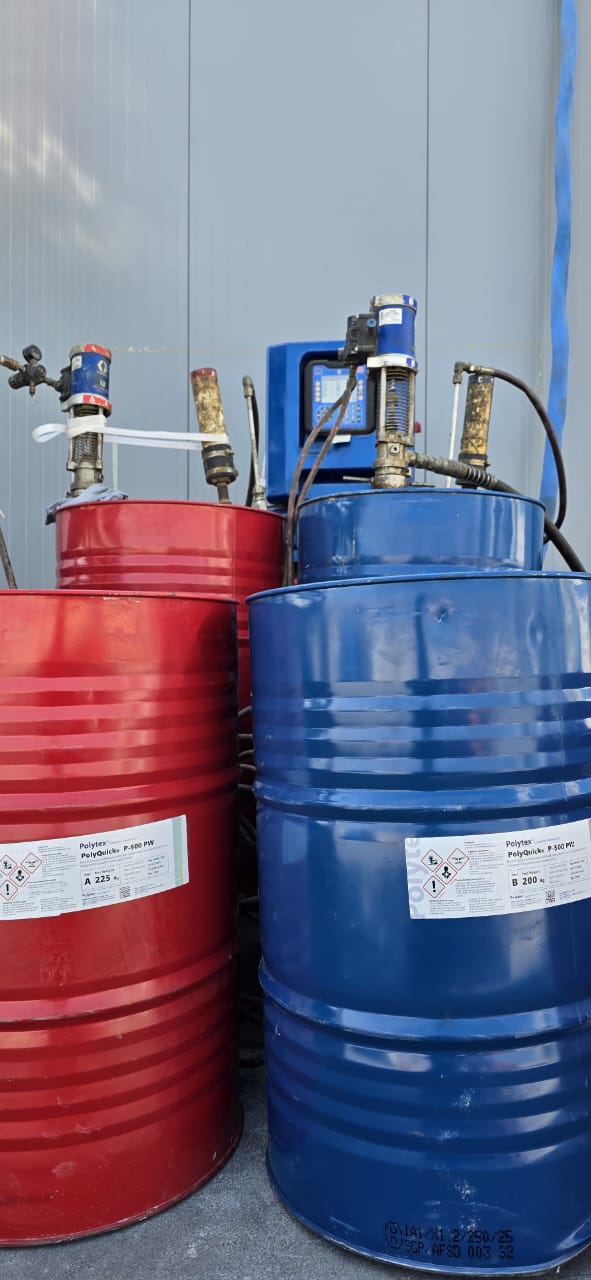 Polytex PolyQuicks P-500 Component A and Component B drums with transfer pumps feeding the plural-component spray rig