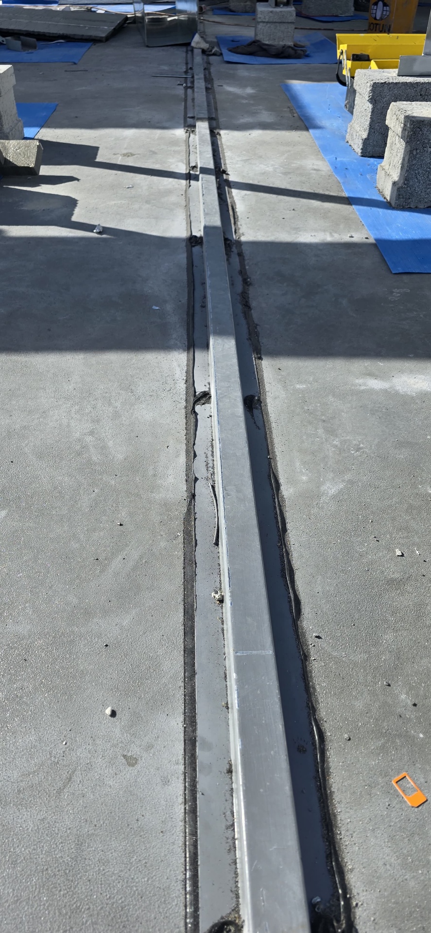 Expansion joint sealed with polyurea-compatible sealant on a concrete deck
