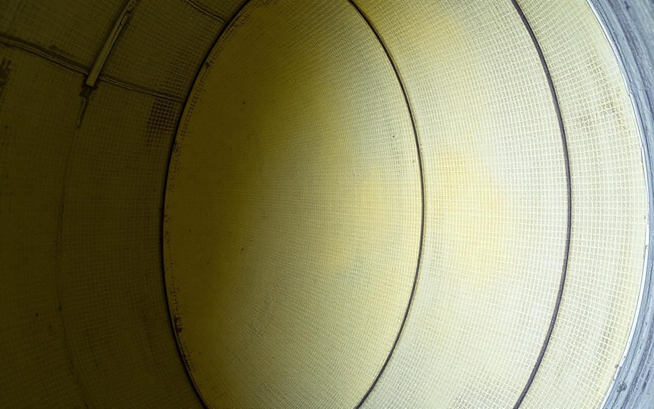 Close-up of GRP fibreglass laminate showing woven mat texture and panel overlap seam
