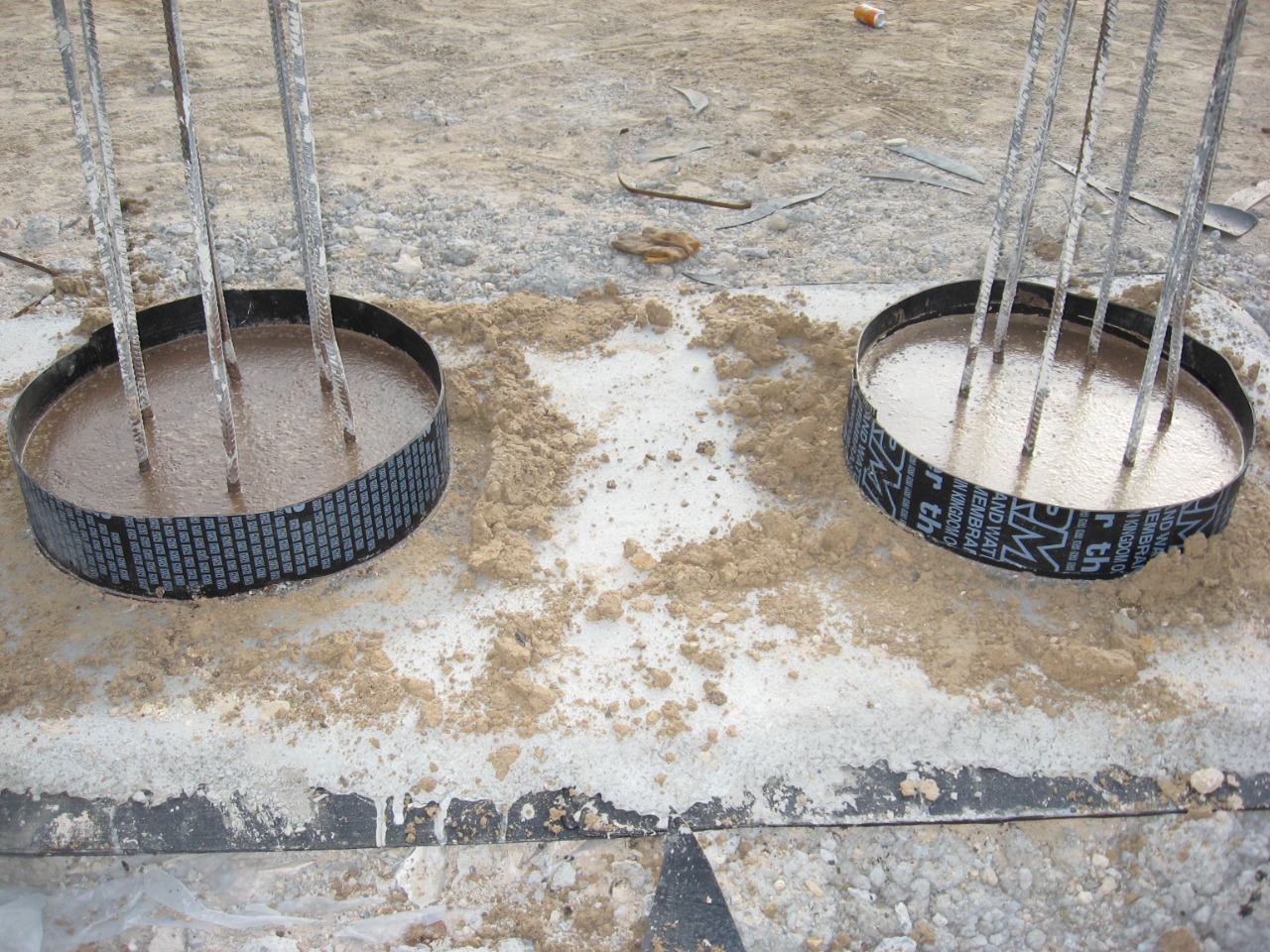 Two completed pile heads with branded membrane collars