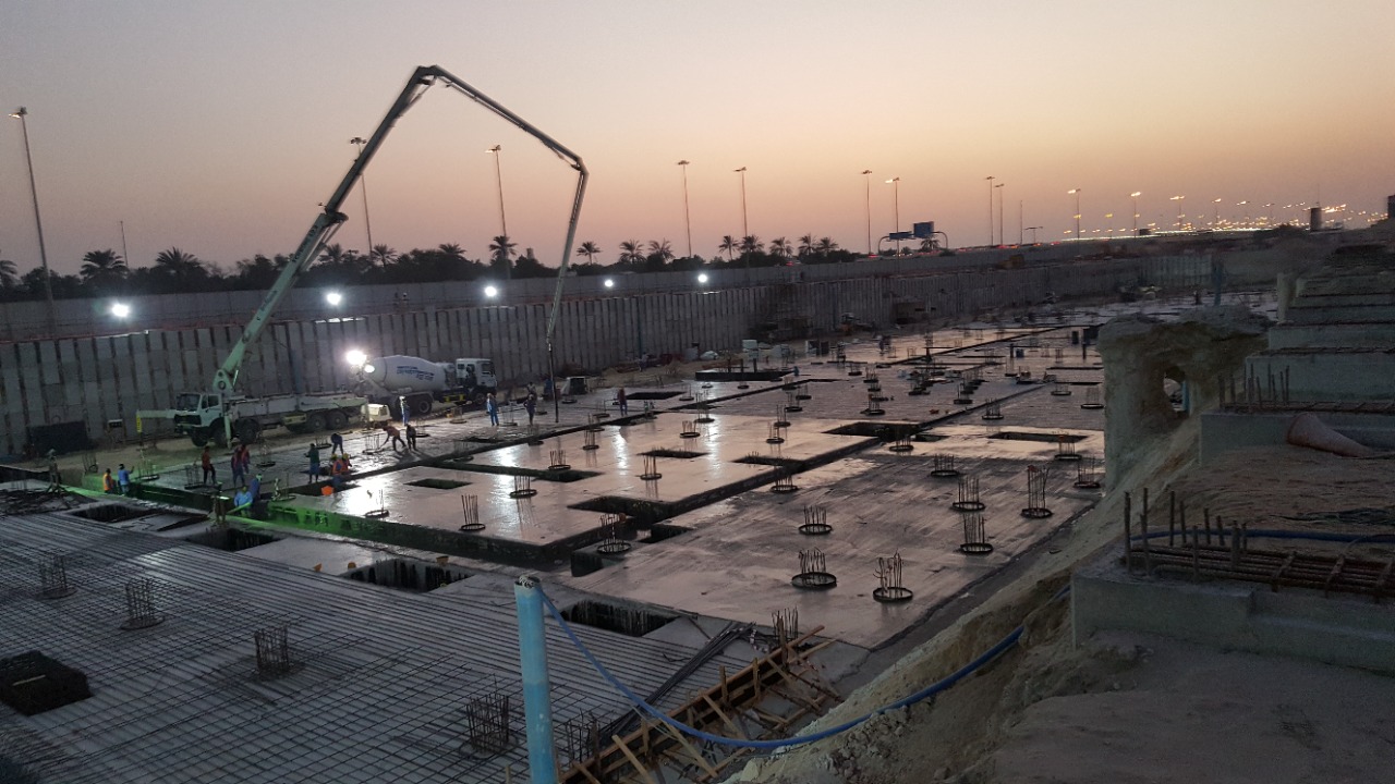 Wide view of treated pile heads on raft foundation at dusk