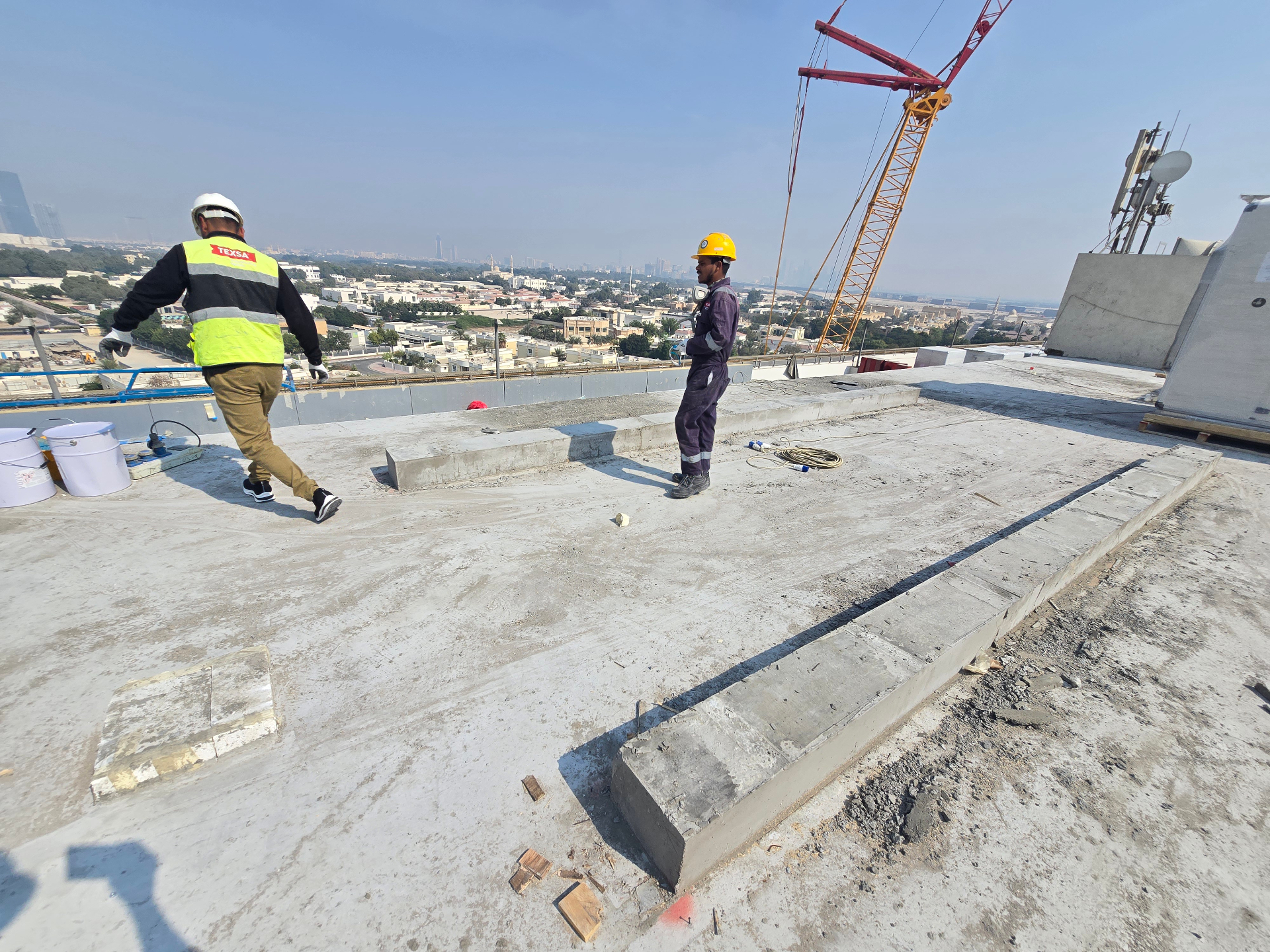 TEXSA crew walking the rooftop slab before polyurea application