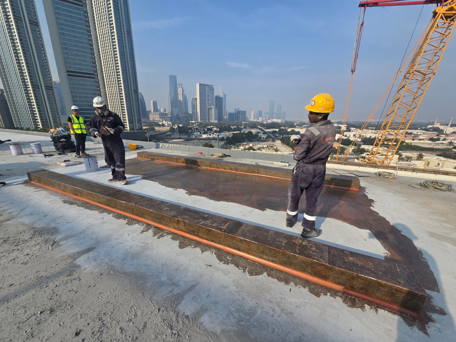 Primed upstands on a high-rise rooftop with the Dubai skyline behind